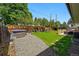 Large backyard featuring a relaxing hot tub, stone pathway, grassy area, and an outdoor dining area at 3275 19Th St, Boulder, CO 80304