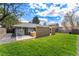 Well-maintained backyard with lush green lawn, patio with outdoor dining, and privacy fence at 3275 19Th St, Boulder, CO 80304