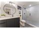 Modern bathroom featuring a sleek vanity, round mirror, and a glass-enclosed tiled shower at 3275 19Th St, Boulder, CO 80304