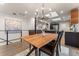 Dining area with a modern chandelier, wooden table, and a view into the adjacent kitchen at 3275 19Th St, Boulder, CO 80304