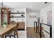 Cozy dining area featuring a wooden table, modern shelving, and hardwood floors near the stairs at 3275 19Th St, Boulder, CO 80304