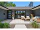 Inviting front porch with modern seating, decorative planters, and stylish entry door, perfect for outdoor relaxation at 3275 19Th St, Boulder, CO 80304