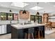 Modern kitchen with a large island, marble countertops, sleek black cabinets, and stainless steel appliances at 3275 19Th St, Boulder, CO 80304