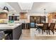 Open kitchen and dining area with a kitchen island, wine fridge, wood cabinets, and sliding door to the outside at 3275 19Th St, Boulder, CO 80304