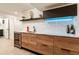 Basement kitchenette with sleek wooden cabinets and a wine cooler at 3275 19Th St, Boulder, CO 80304
