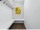 A stylish mudroom features coat hooks, a bench, and eye-catching bicycle-themed wall art at 3275 19Th St, Boulder, CO 80304
