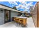 Outdoor kitchen and entertaining area with grill, bar seating, and concrete patio at 3275 19Th St, Boulder, CO 80304
