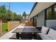 Inviting outdoor patio with a built-in grill, dining table, comfortable seating and access to the backyard at 3275 19Th St, Boulder, CO 80304