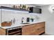 Basement wet bar featuring wine fridge, wood cabinets, white countertops, and hexagon backsplash at 3275 19Th St, Boulder, CO 80304