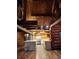 Bright and airy kitchen showcases wood beam ceilings, stone counters, and log walls at 733 Rainbow Rd, Idaho Springs, CO 80452