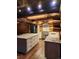 Rustic kitchen with granite counters, stainless appliances, log walls and ceiling, and wood floors at 733 Rainbow Rd, Idaho Springs, CO 80452