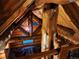 A look down to the living room from the loft area showcasing the wood beam architecture at 733 Rainbow Rd, Idaho Springs, CO 80452