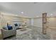 This is a finished basement with tile floors, recessed lighting, and a painted brick column at 1552 Hudson St, Denver, CO 80220