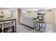 Finished basement with a decorative brick pillar, comfortable seating, a TV, and tile flooring at 1552 Hudson St, Denver, CO 80220