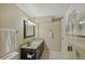 Well-lit bathroom features granite counters, a sleek black vanity, and a modern mirror at 1552 Hudson St, Denver, CO 80220