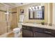 Updated bathroom featuring a glass-enclosed shower and a vanity with granite countertop at 1552 Hudson St, Denver, CO 80220
