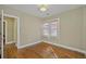 An empty bedroom with hardwood floors, neutral colored walls, and white trim at 1552 Hudson St, Denver, CO 80220