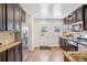 Modern kitchen features dark cabinetry, stainless steel appliances, granite countertops, and hardwood floors, plus an exterior door at 1552 Hudson St, Denver, CO 80220