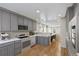 Open-concept kitchen featuring light gray cabinetry, stainless steel appliances, plus an eat-in area with backyard views at 1552 Hudson St, Denver, CO 80220
