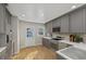 Updated kitchen features light gray cabinetry, stainless steel appliances, bright countertops, and hardwood flooring at 1552 Hudson St, Denver, CO 80220
