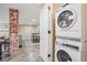 Convenient laundry area with stacked washer and dryer; adjacent to a finished living area at 1552 Hudson St, Denver, CO 80220