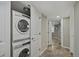 Convenient laundry area featuring a stacked washer and dryer, and doorway to the hallway at 1552 Hudson St, Denver, CO 80220