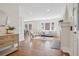 Bright living room with hardwood floors, fireplace, comfortable seating, and an open layout to the dining area at 1552 Hudson St, Denver, CO 80220