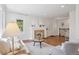 Bright living room featuring hardwood floors, fireplace, white walls, and a cozy seating arrangement at 1552 Hudson St, Denver, CO 80220