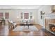Sunlit living room featuring hardwood floors, fireplace, comfortable seating, and large windows at 1552 Hudson St, Denver, CO 80220