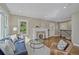 Bright living room featuring hardwood floors, a decorative fireplace, and comfortable seating arrangement at 1552 Hudson St, Denver, CO 80220