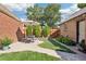 Outdoor patio with dining set, decorative plants and well-manicured lawn at 1552 Hudson St, Denver, CO 80220