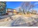 Charming two-story home with a brick exterior, attached garage, and well-manicured front yard at 8487 Yarrow Ct, Arvada, CO 80005