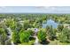 Stunning aerial view of a luxurious home nestled among lush greenery and a serene lake at 13 Buell Mansion Pkwy, Englewood, CO 80113