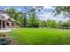 Expansive backyard with lush lawn and mature trees, providing ample space at 13 Buell Mansion Pkwy, Englewood, CO 80113
