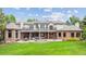 Expansive backyard with lush lawn, patio area, fountain, and multi-level outdoor living at 13 Buell Mansion Pkwy, Englewood, CO 80113