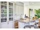 Bar area with glass cabinet, gray cabinets, and counter seating at 13 Buell Mansion Pkwy, Englewood, CO 80113