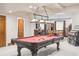 Spacious basement with pool table, jukebox, and lighting at 13 Buell Mansion Pkwy, Englewood, CO 80113