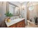 Elegant powder room featuring a granite countertop, framed mirror, and stylish light fixtures at 13 Buell Mansion Pkwy, Englewood, CO 80113