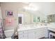 Bright bathroom with white vanity, large mirror, and plenty of counter space at 13 Buell Mansion Pkwy, Englewood, CO 80113