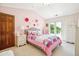 Charming pink bedroom features a decorative rose theme and a private balcony at 13 Buell Mansion Pkwy, Englewood, CO 80113