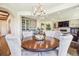 Dining area with bar and fireplace with mounted TV in an open floor plan at 13 Buell Mansion Pkwy, Englewood, CO 80113
