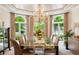 Elegant dining room with a grand chandelier and serene views at 13 Buell Mansion Pkwy, Englewood, CO 80113