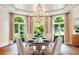 Elegant dining room with hardwood floors, backyard views, and a stunning chandelier at 13 Buell Mansion Pkwy, Englewood, CO 80113