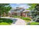Stately home with brick facade, lush landscaping, and circular driveway at 13 Buell Mansion Pkwy, Englewood, CO 80113