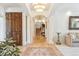Grand foyer with columns, tile floors, and elegant lighting at 13 Buell Mansion Pkwy, Englewood, CO 80113