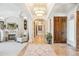 Grand foyer with fireplace, travertine floors, and ornate details at 13 Buell Mansion Pkwy, Englewood, CO 80113