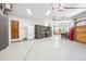 Spacious three-car garage with epoxy flooring, storage cabinets and plenty of space at 13 Buell Mansion Pkwy, Englewood, CO 80113
