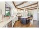 Bright kitchen with stainless appliances, a center island, and hardwood floors at 13 Buell Mansion Pkwy, Englewood, CO 80113