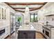 A gourmet kitchen features a center island, stainless appliances, and wood floors at 13 Buell Mansion Pkwy, Englewood, CO 80113