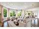 Spacious living room with abundant natural light, comfortable seating, and a view of the yard at 13 Buell Mansion Pkwy, Englewood, CO 80113